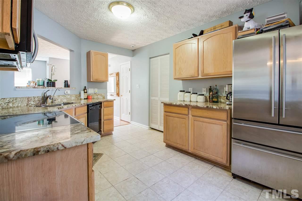 5729 Forest Point Road Raleigh, NC 27610 - Photo 8 of 26 a kitchen with a sink stove and refrigerator