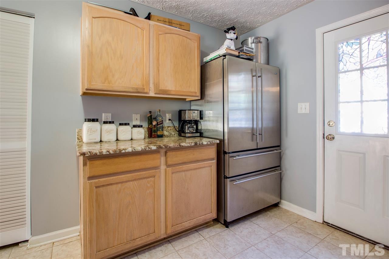 5729 Forest Point Road Raleigh, NC 27610 - Photo 10 of 26 a kitchen with stainless steel appliances granite countertop a refrigerator sink and cabinets