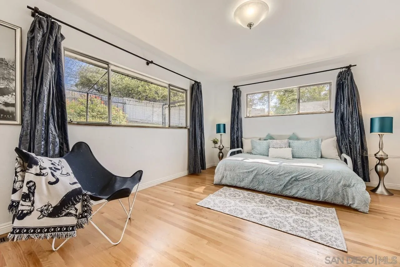 10158 Madrid Way Spring Valley, CA 91977 - Photo 16 of 27 a bedroom with a bed and wooden floor