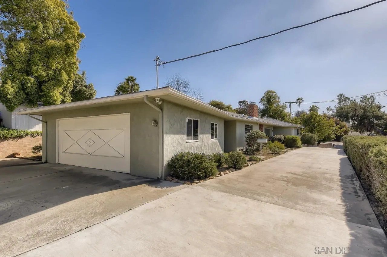 10158 Madrid Way Spring Valley, CA 91977 - Photo 2 of 27 a front view of a house with a yard and garage