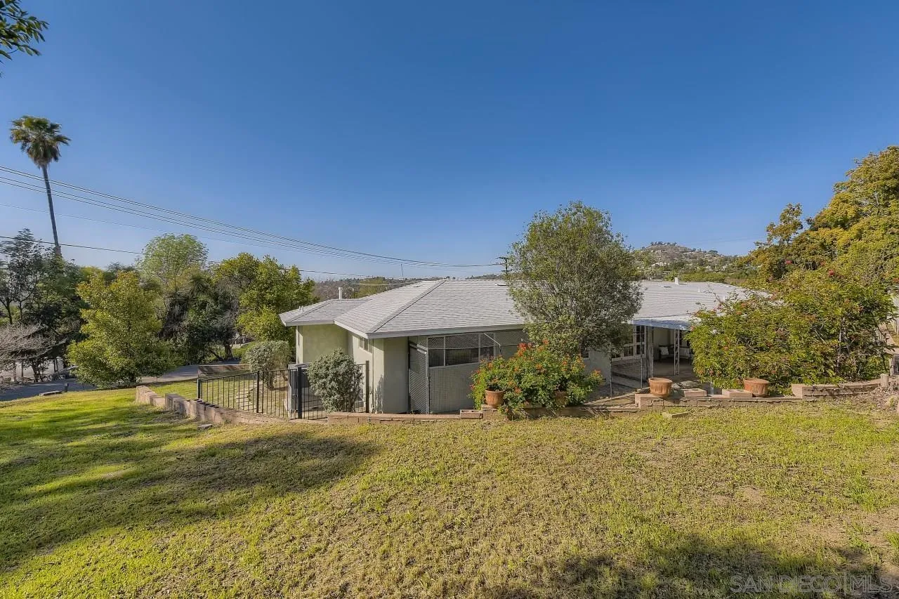 10158 Madrid Way Spring Valley, CA 91977 - Photo 24 of 27 a front view of a house with a yard