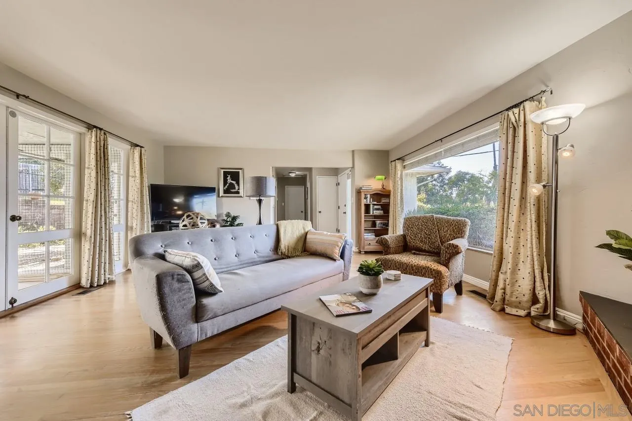 10158 Madrid Way Spring Valley, CA 91977 - Photo 5 of 27 a living room with furniture a large window and a rug