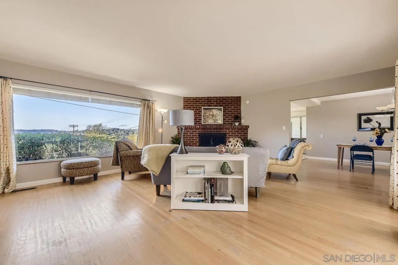 10158 Madrid Way Spring Valley, CA 91977 - Photo 6 of 27 a living room with furniture floor to ceiling window and a table