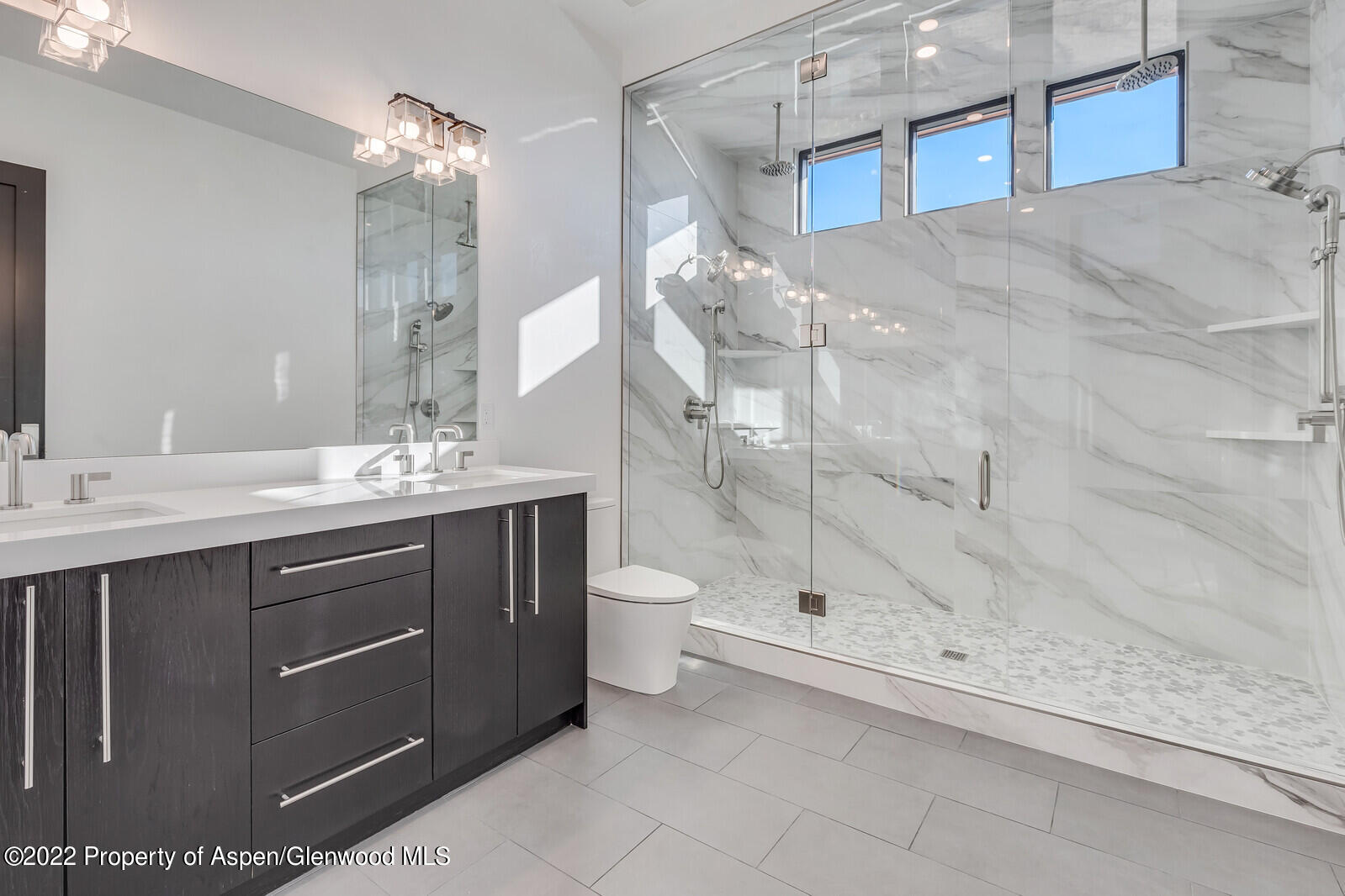 1093 Callicotte Ranch Road Carbondale, CO 81623 - Photo 23 of 27 a bathroom with a double vanity sink toilet and shower