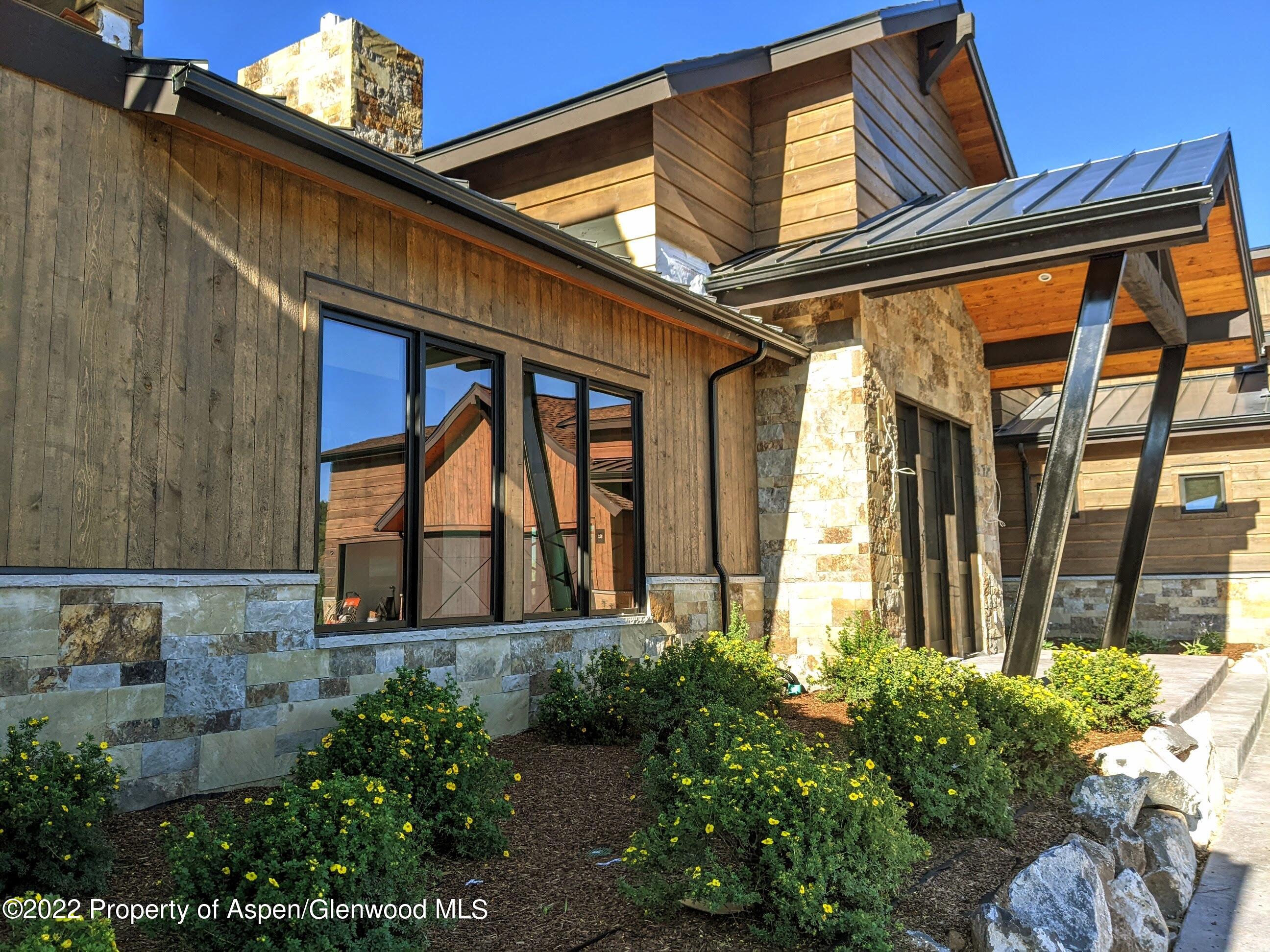1093 Callicotte Ranch Road Carbondale, CO 81623 - Photo 25 of 27 a front view of a house with a garden