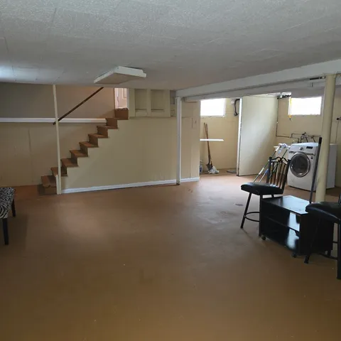 a view of a room with gym equipment and windows