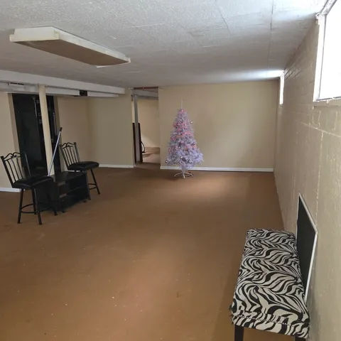 a room with gym equipment and view of living room