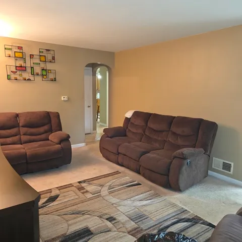 a living room with couches and balcony