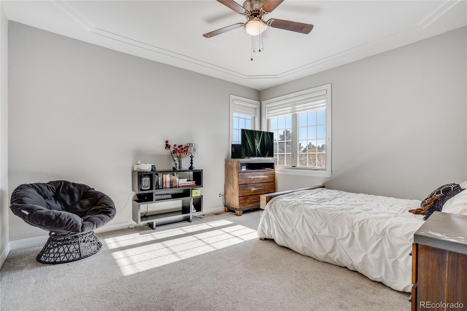 7285 Sagebrush Drive Parker, CO 80138 - Photo 31 of 46 a bedroom with a bed and a chandelier