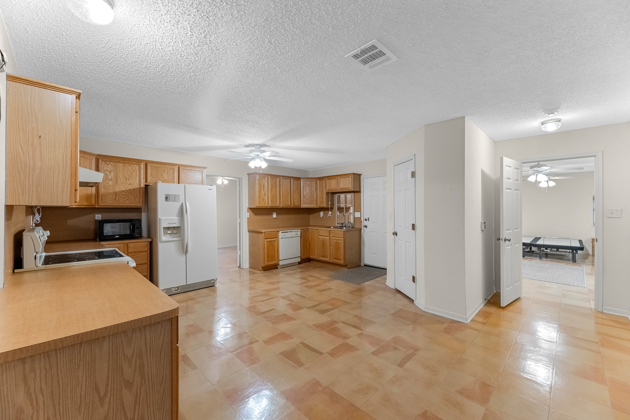 7315 Pine Street Manvel, TX 77578 - Photo 37 of 50 a view of a kitchen with a sink and refrigerator