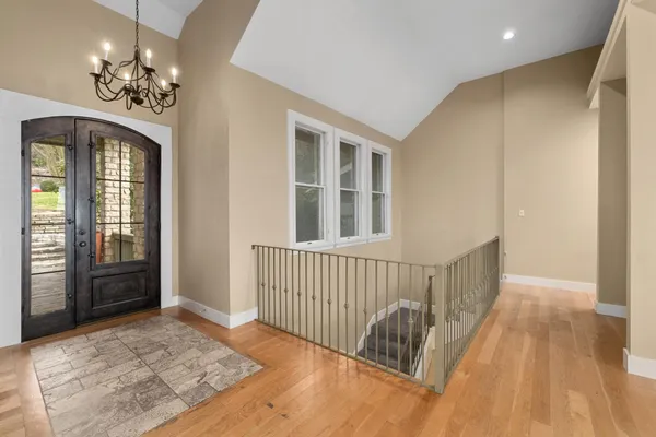 a view of a bedroom with wooden floor and windows