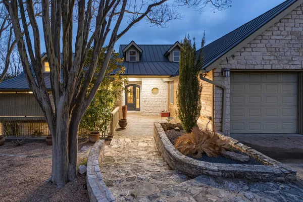 a view of a house with backyard and sitting area