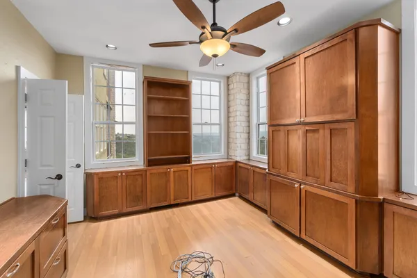 a kitchen with stainless steel appliances wooden floor and a window