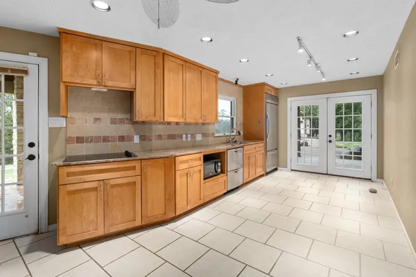 a kitchen with stainless steel appliances granite countertop a stove a sink and a refrigerator