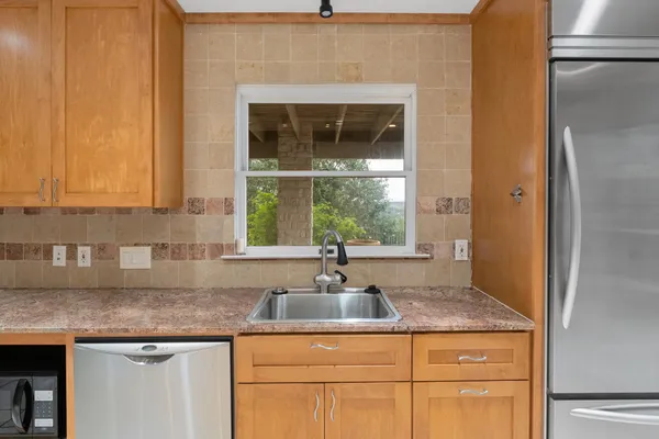 a kitchen with granite countertop a sink and a window