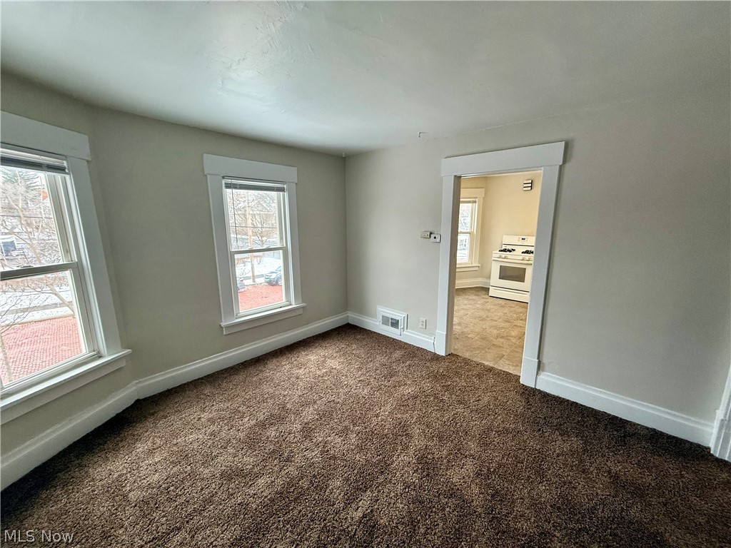 39 North Balch Street Akron, OH 44303 - Photo 7 of 19 Spare room with baseboards and dark colored carpet