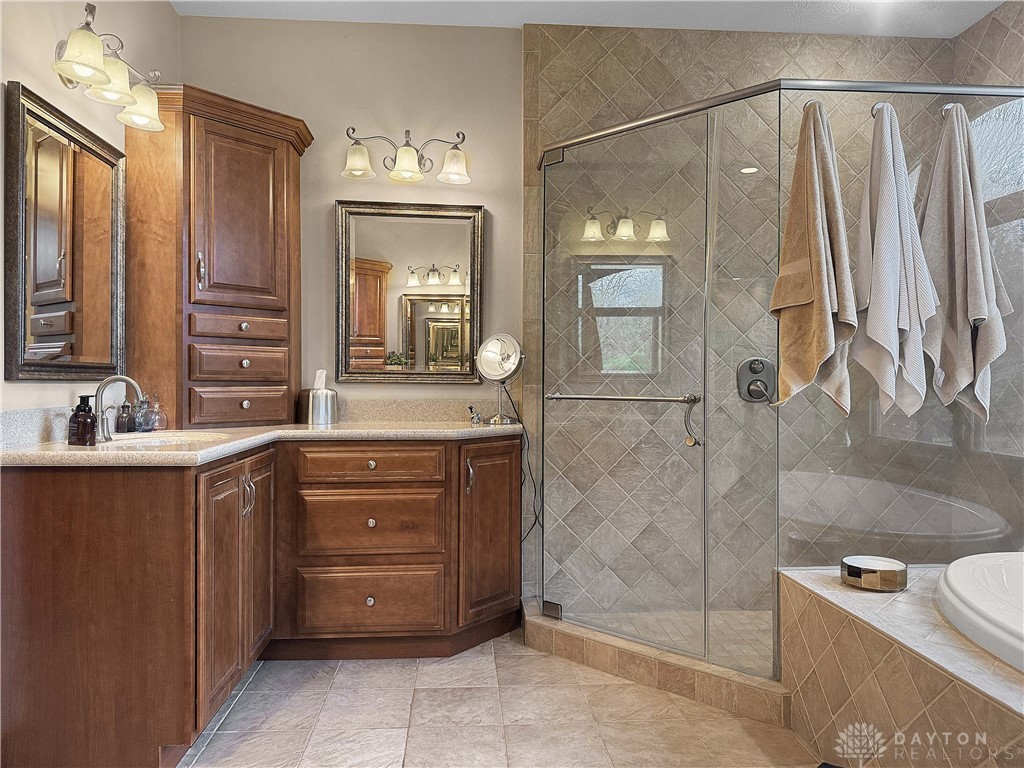 4096 Middle Urbana Road Urbana, OH 43078 - Photo 67 of 96 This bathroom features a spacious shower, a whirlpool tub, and a vanity with ample storage.