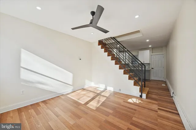 a view of entryway and hall with wooden floor