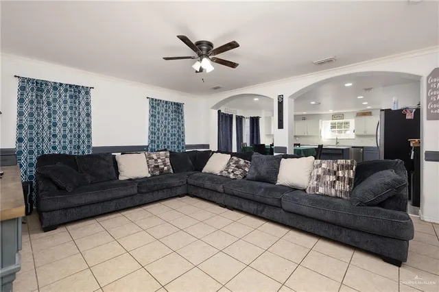 a living room with a couch and a view of kitchen