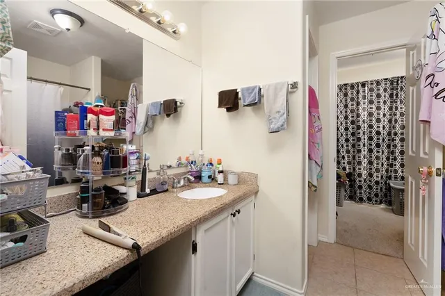 a kitchen with a sink dishwasher and a refrigerator with wooden floor