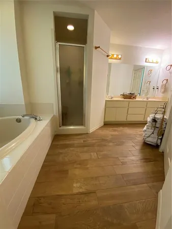 a spacious bathroom with a tub and shower