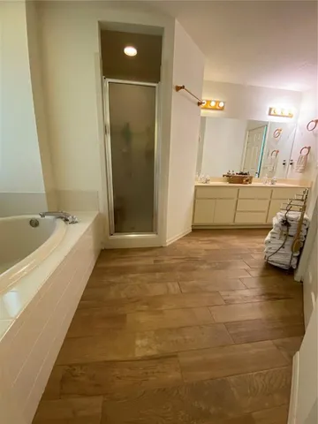 a spacious bathroom with a tub and shower