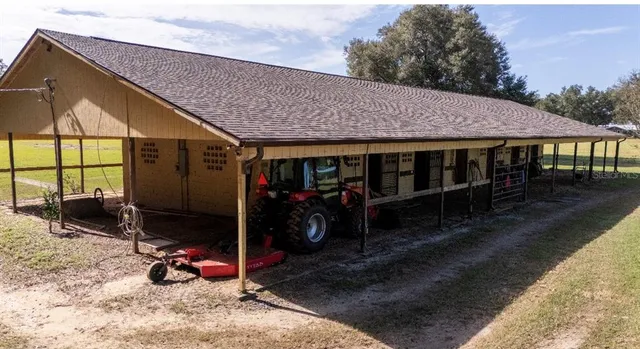 a view of a house with wooden roof and sitting area