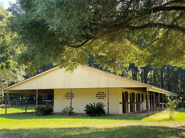 a backyard of a house with barbeque oven table and chairs