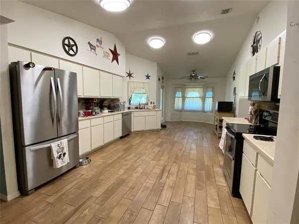 a kitchen with stainless steel appliances a refrigerator stove microwave and cabinets