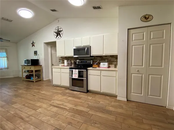 a kitchen with stainless steel appliances and white cabinets