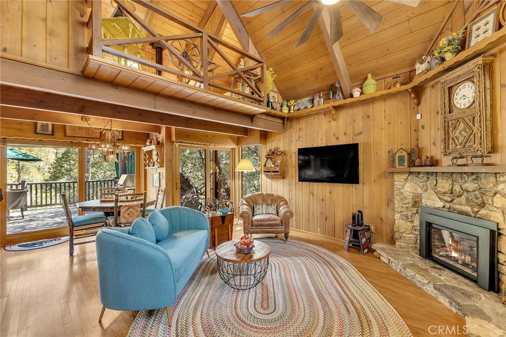 25300 Pine Crest Avenue Idyllwild, CA 92549 - Photo 14 of 75 Living room with stunning views from the rear windows overlooking the deck and forest.