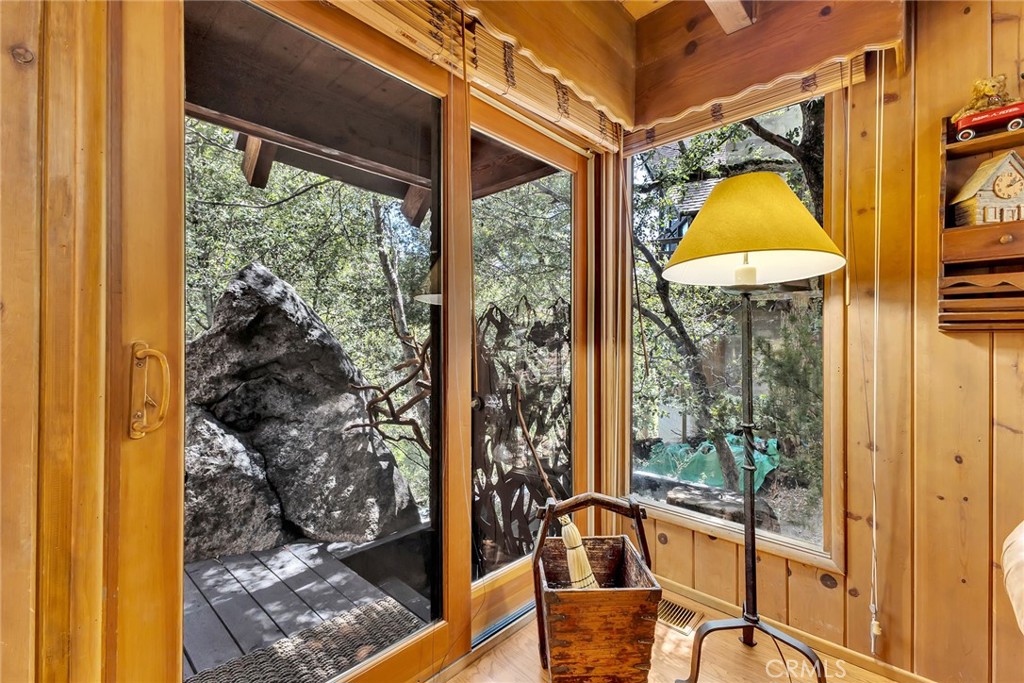 25300 Pine Crest Avenue Idyllwild, CA 92549 - Photo 17 of 75 Custom sculpted gate as seen through this large windows lead to the stairs to the large forested property.