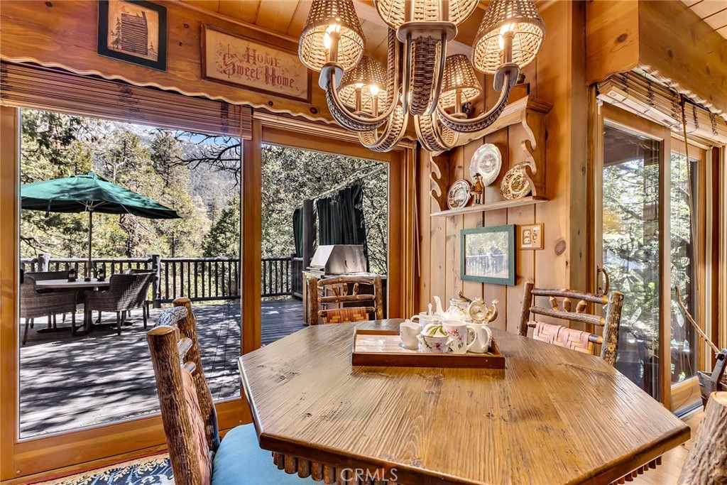 25300 Pine Crest Avenue Idyllwild, CA 92549 - Photo 49 of 75 Dining area wit sliding door leading to expansive rear deck overlooking the forested property.