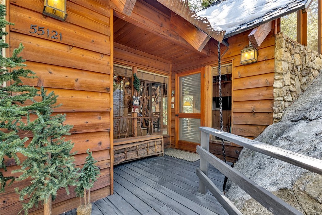 25300 Pine Crest Avenue Idyllwild, CA 92549 - Photo 10 of 75 Front porch and entrance with a glimpse of the boulder the living room is build around.