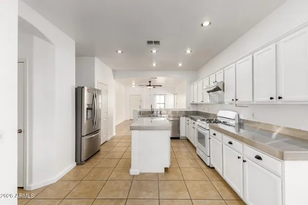 a kitchen with stainless steel appliances granite countertop a refrigerator and a sink