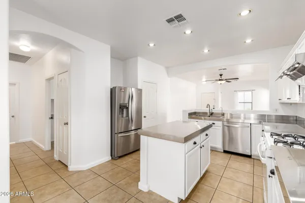 a kitchen with a sink stove and refrigerator