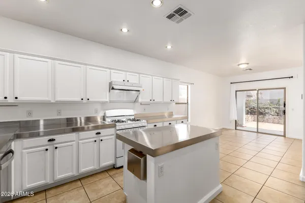 a kitchen with a sink window and cabinets