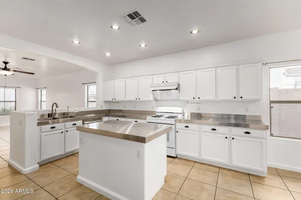a kitchen with cabinets appliances a sink and a counter top space