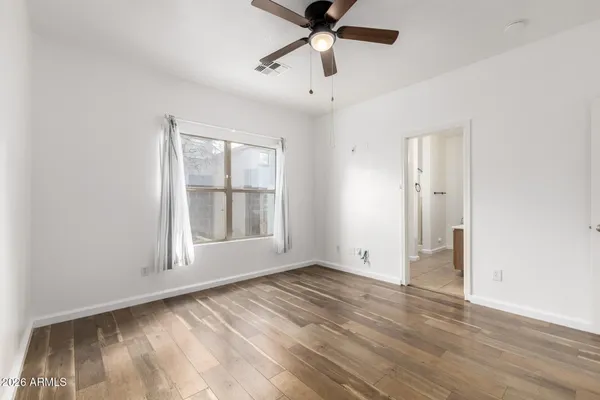 wooden floor in an empty room with a window
