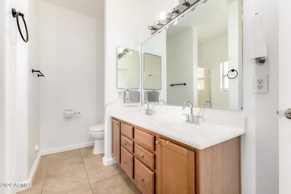 a bathroom with a double vanity sink toilet and shower