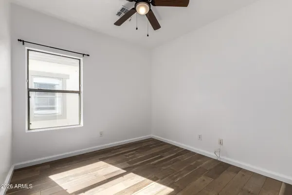 a view of wooden floor and windows in a room