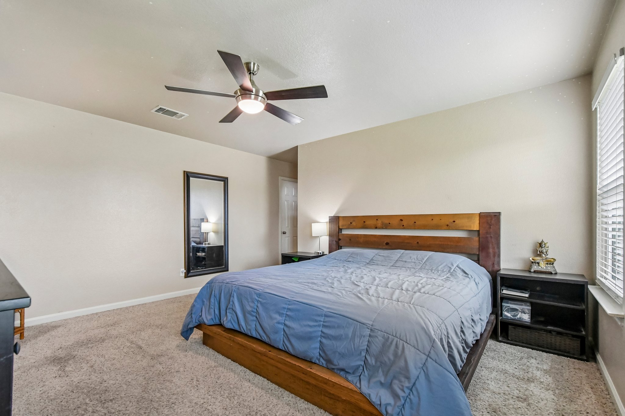 125 Mason Reed Cove Kyle, TX 78640 - Photo 33 of 39 a bedroom with a bed and a chandelier