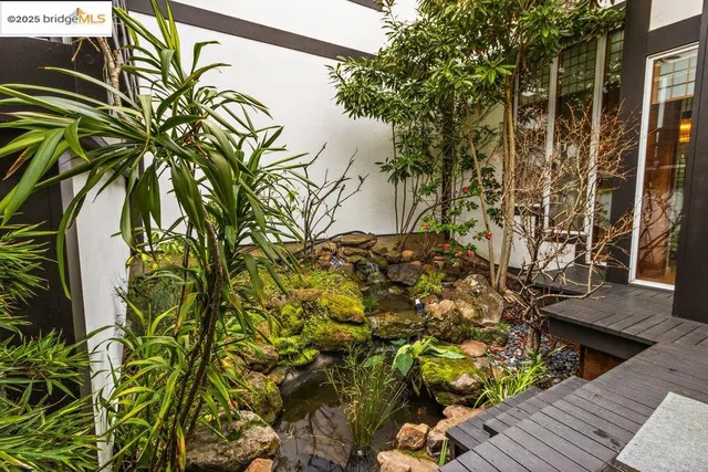 a balcony with wooden floor outdoor seating and city view