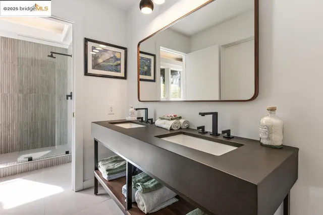 a living room with furniture a large window and a potted plant on a table