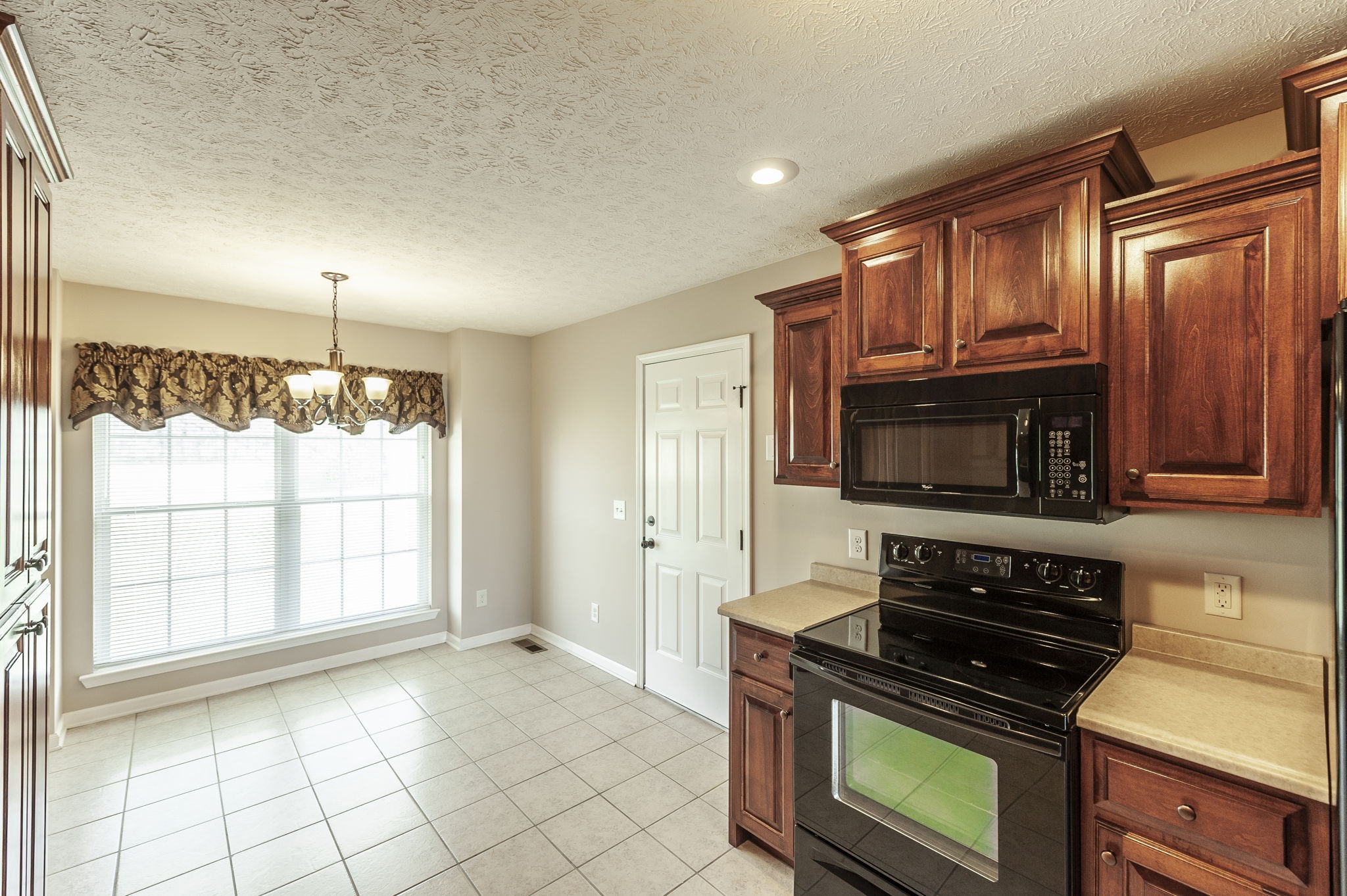 7535 Swift Road Greenbrier, TN 37073 - Photo 11 of 51 a kitchen with granite countertop a stove cabinets and microwave