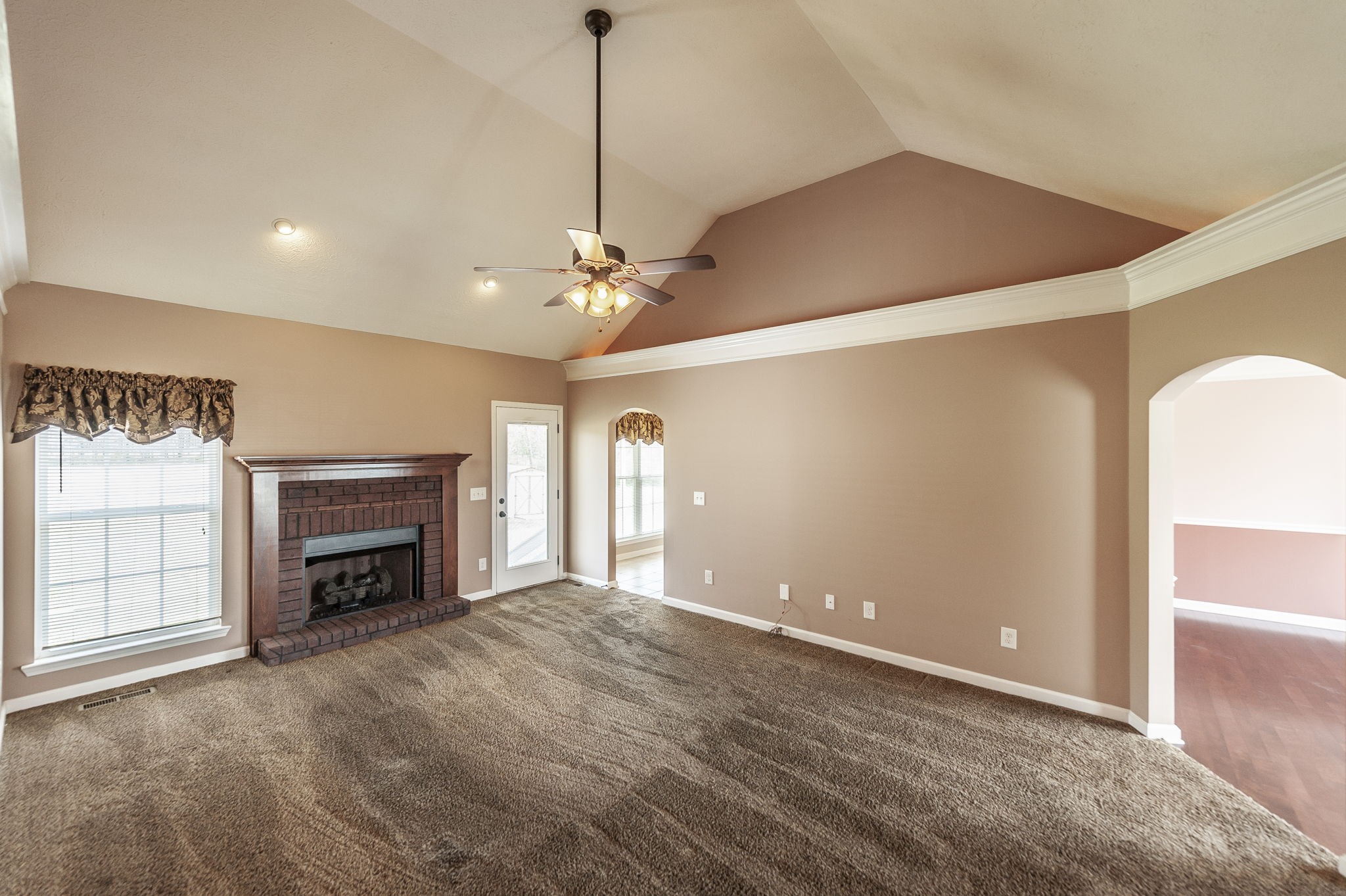 7535 Swift Road Greenbrier, TN 37073 - Photo 20 of 51 a view of a livingroom with a fireplace a chandelier and windows