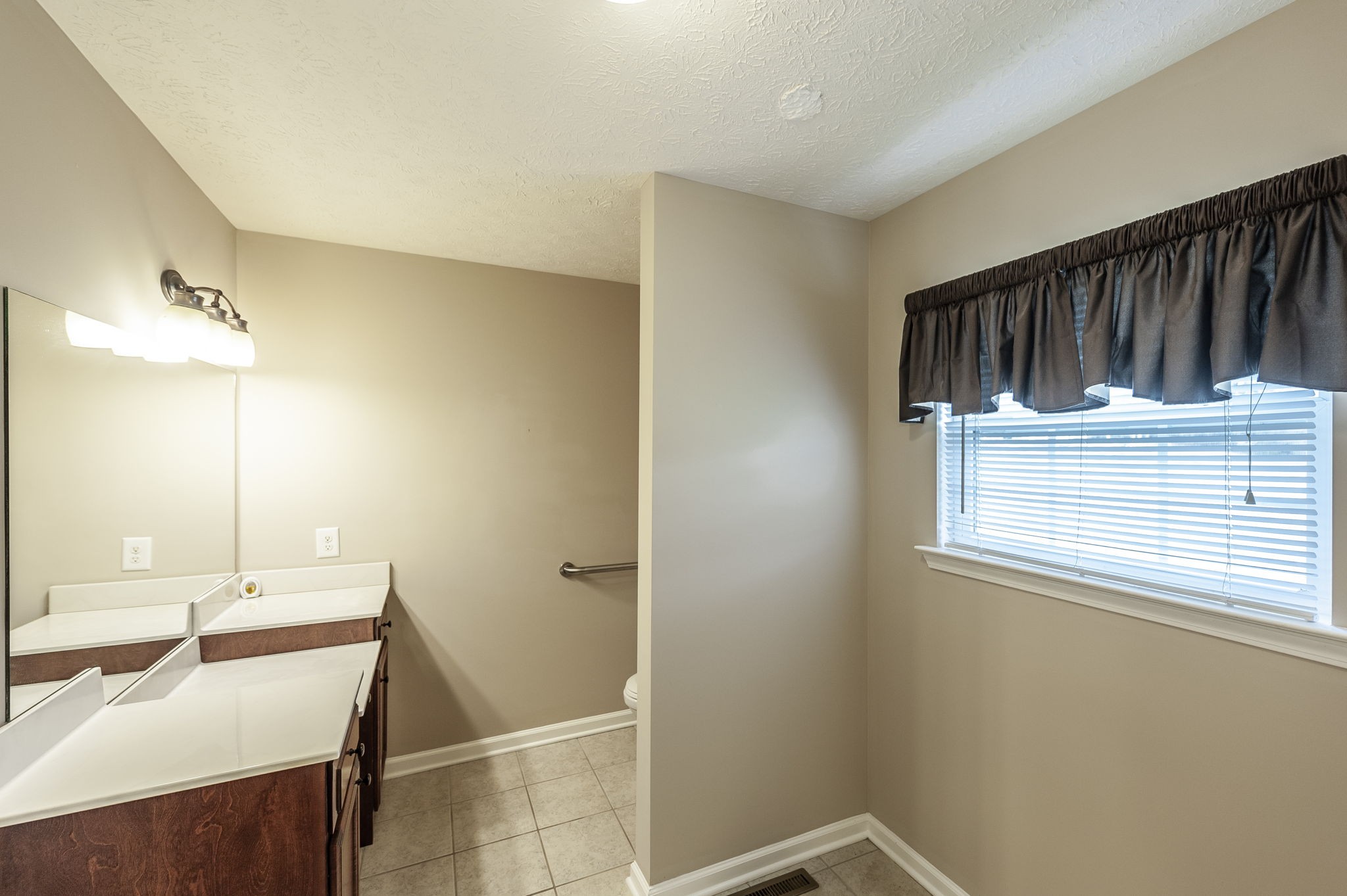 7535 Swift Road Greenbrier, TN 37073 - Photo 32 of 51 a bathroom with a sink a mirror and shower