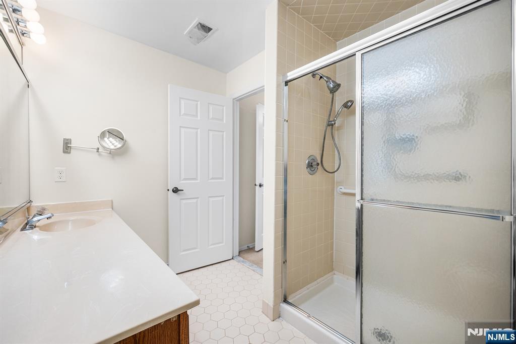 11A Rothwell Drive, Unit 11D Monroe Township, NJ 08831 - Photo 23 of 47 a bathroom with a shower and a sink