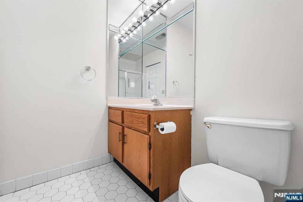 11A Rothwell Drive, Unit 11D Monroe Township, NJ 08831 - Photo 29 of 47 a bathroom with a sink a toilet a mirror and shower