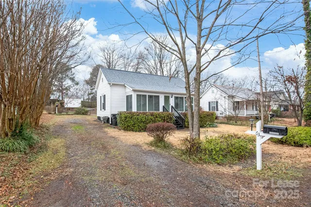a view of a house with a yard covered in snow